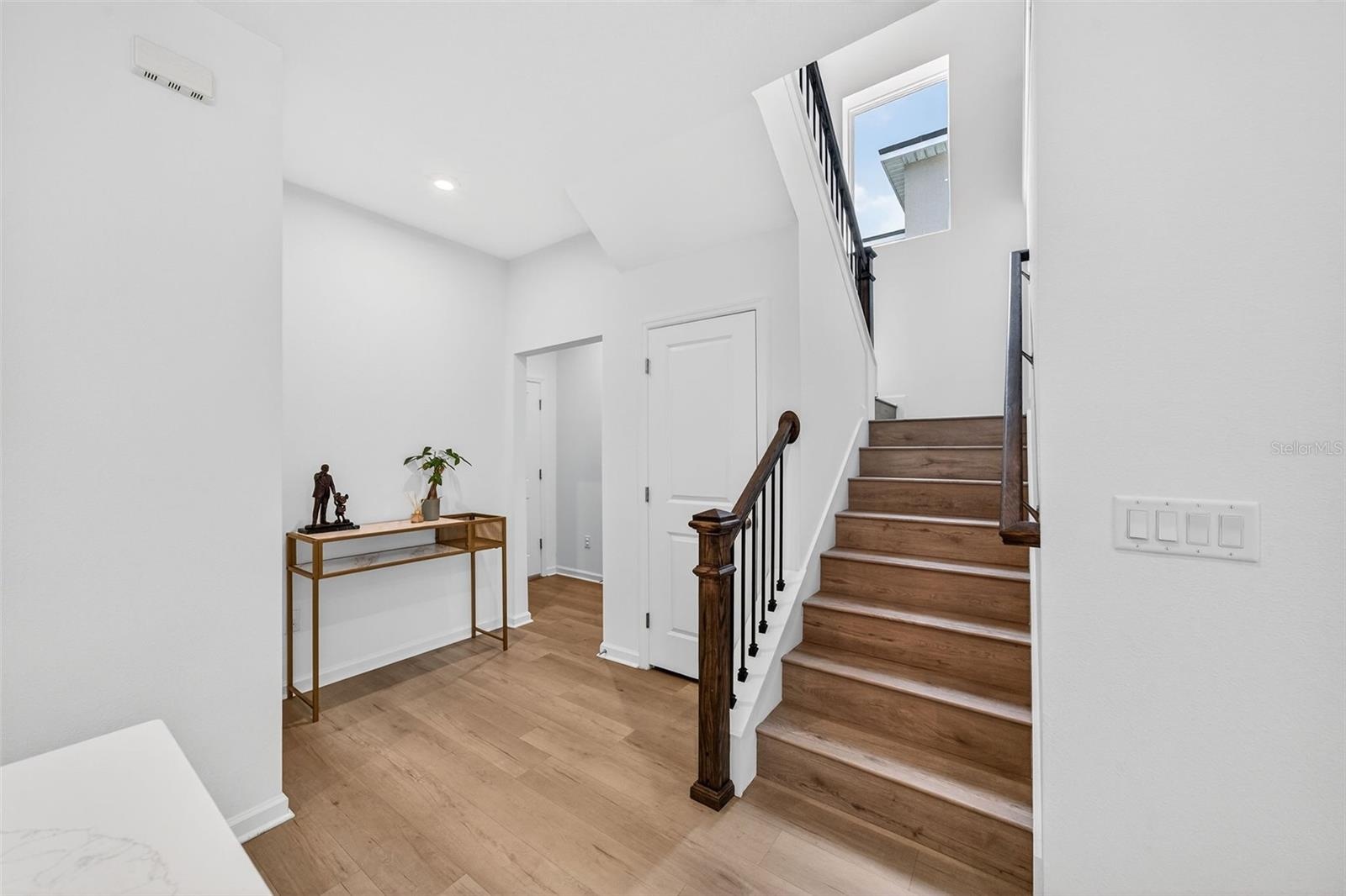 Stair landing, half bathroom and mud room