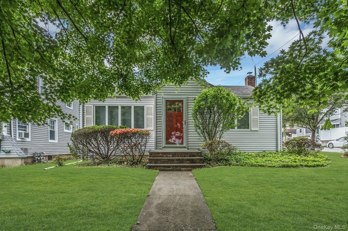 Light-colored siding exterior with white window shutters