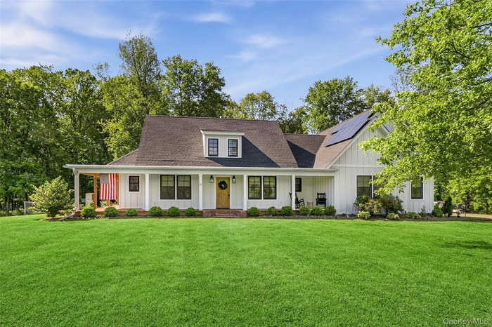 Font exterior showcasing the modern farmhouse design and expansive front lawn