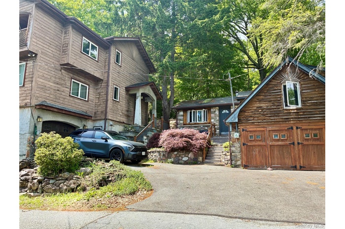 Two homes  - on left contemporary 2 br plus large den, open living room kitchen, garage, fireplace. Master bedroom with vaulted ceilings balcony and l