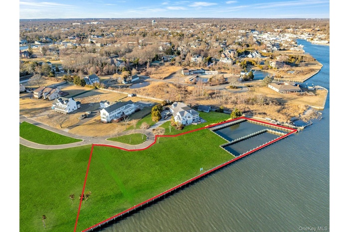 Aerial overview of property's location with property boundaries highlighted and a nearby body of water