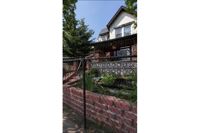 Front exterior view of property featuring the main entrance and front yard.