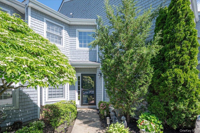 Shingle siding exterior with white trim accents and an inviting entryway