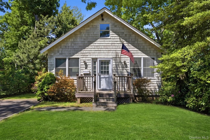 Single-story residence featuring light gray shingle siding