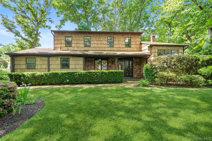 Exterior showcasing cedar shingle siding and brick accents