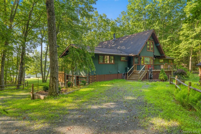 Chalet / cabin with a wooden deck and stairs