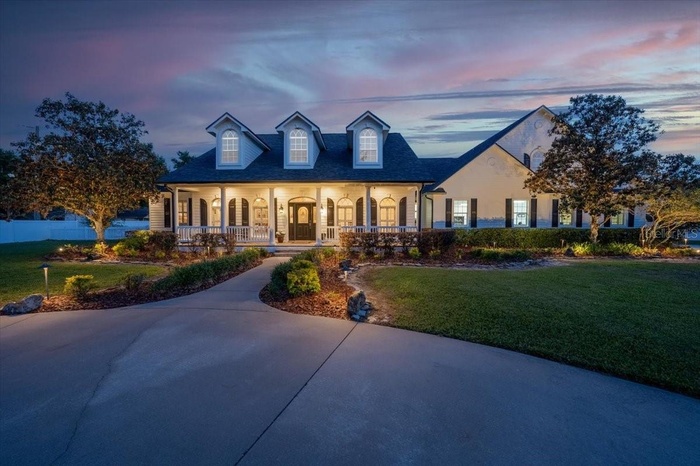Stunning gated estate with timeless architecture and expansive curb appeal