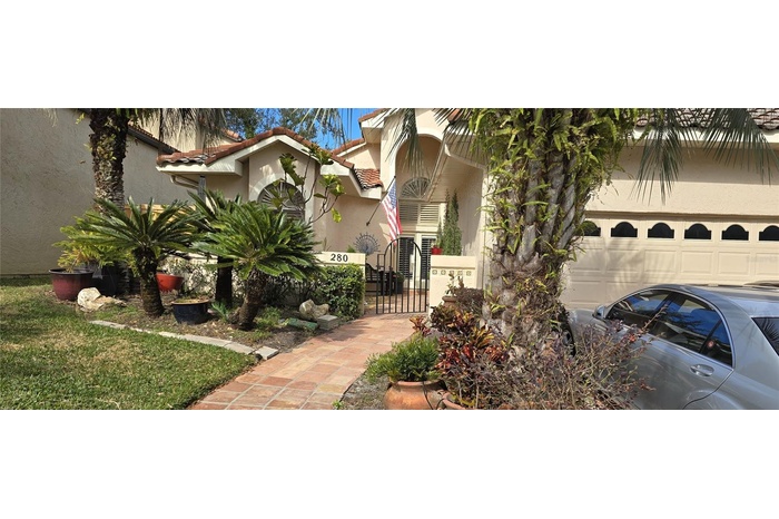 Beautiful mature trees of frontal view of 4 bedroom 3 bath home