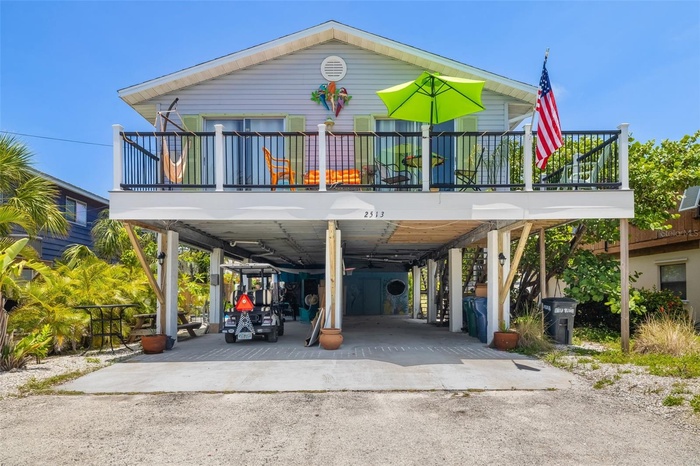 Elevated coastal home with covered parking and spacious upper-level deck, just blocks from the Gulf and steps to Sarasota Bay.