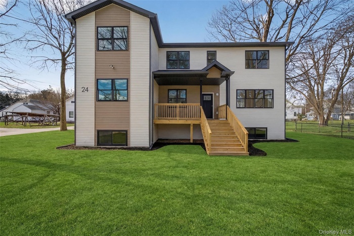 Rear view of property with stairs and covered porch