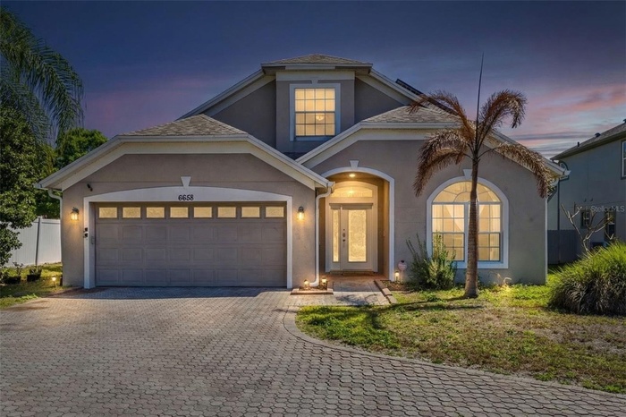 Twilight. Beautiful 5 bedroom, 3 bathroom pool home with approximately 2,530 square feet of living space situated on an oversized 0.30 acre flag lot, 