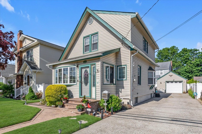 Traditional home with long driveway, beautifully landscaped yard and pavers, 1.5 car garage