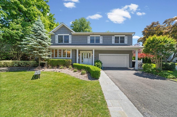 Two-story residential exterior with gray siding and white trim