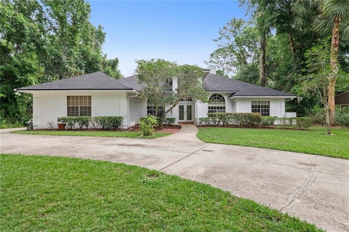 Front of with 3 car side entry garage and long driveway