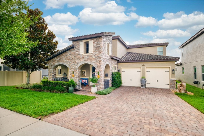North-facing front elevation featuring a two-car garage and a welcoming front porch.