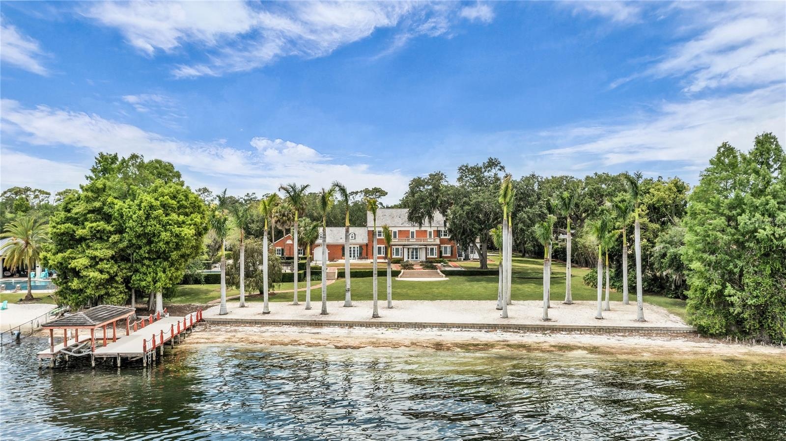 Sandy beach and dock with boat lift and 2 jet ski lifts