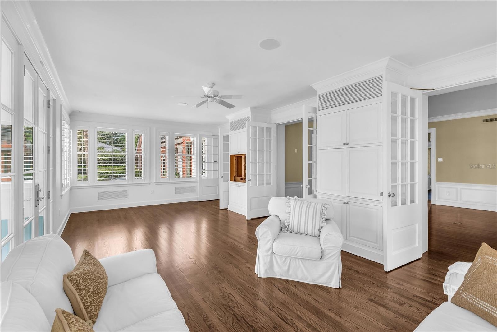 Sunroom with French doors leading to the beautiful backyard