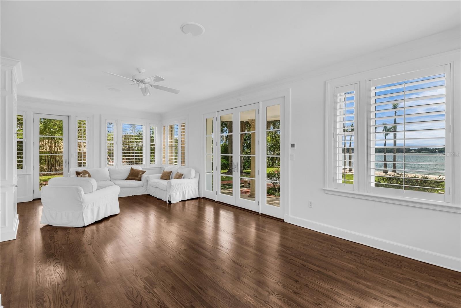 Sunroom with French doors leading to the beautiful backyard