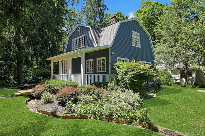 A beautiful view from the front of the property leads toward the backyard, showcasing the home’s inviting setting and the natural beauty that surround