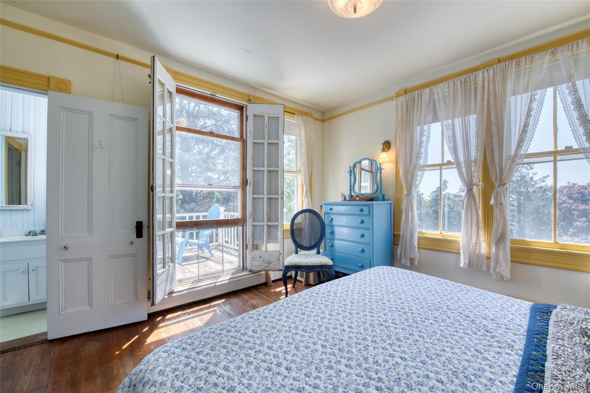 primary bedroom with half bath & private balcony