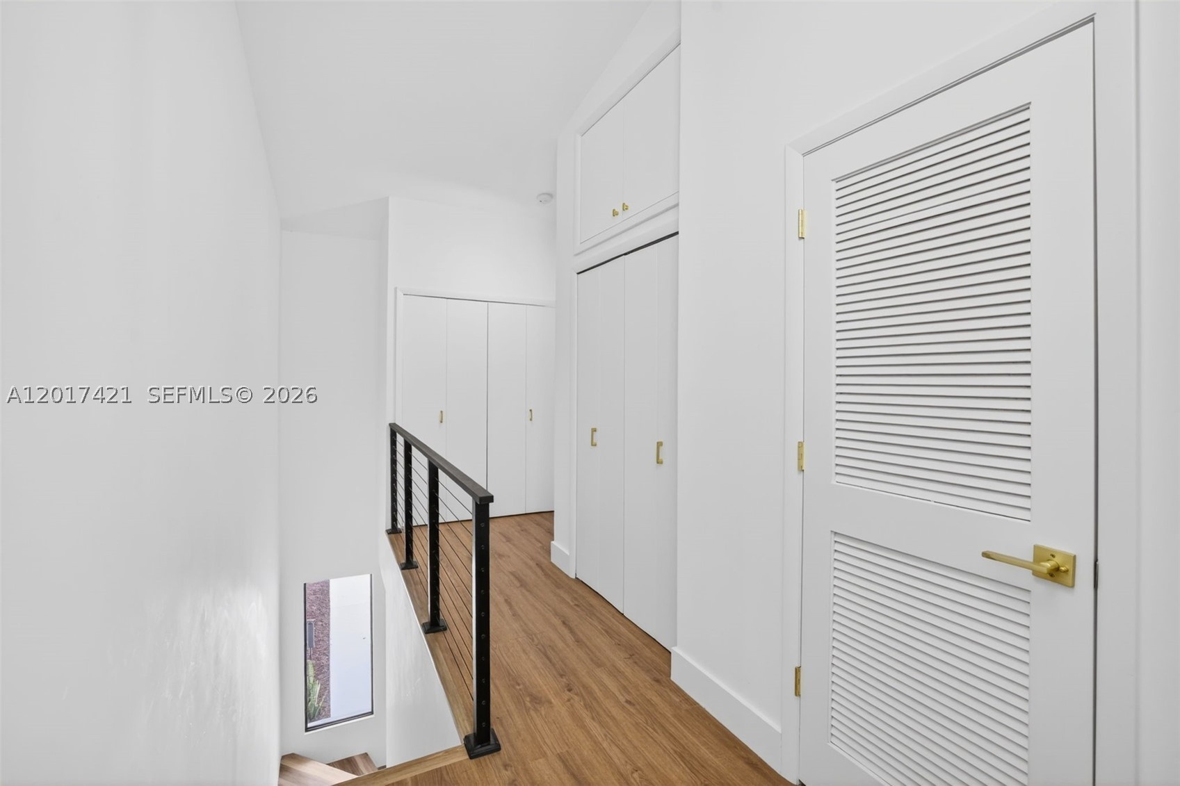 New railing / balister system w/ cables & aluminum. New doors & hardware & freshly pained. AC closet to right, storage closet and Laundry Area straigh
