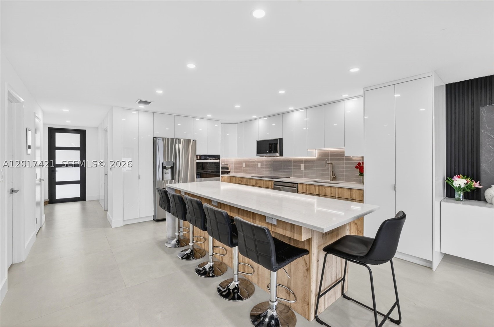 Counter seating for 5 seats (extra one on end makes 6). Beautiful impact front door for more natural light. any high hats in ceiling for kitchen light
