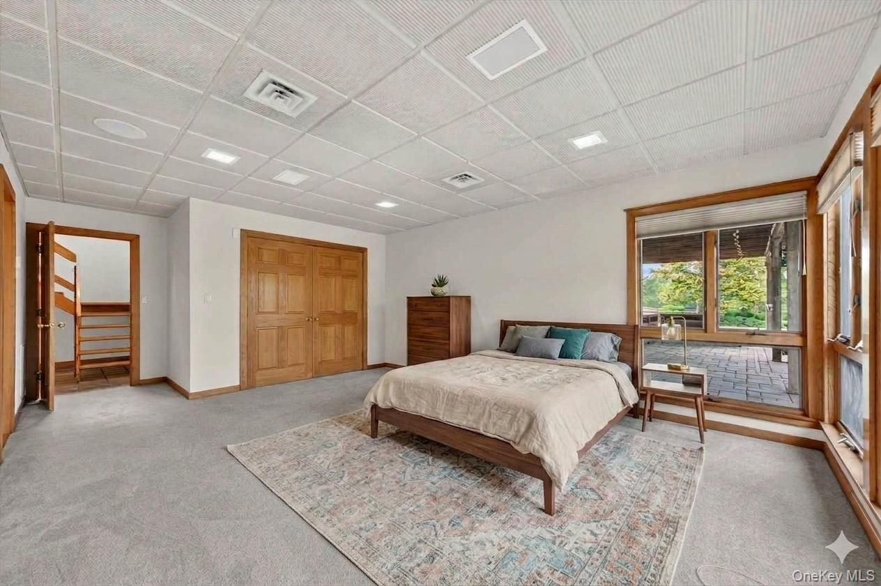 One of two bedrooms on the lower level with direct access to the pool deck*virtually staged*