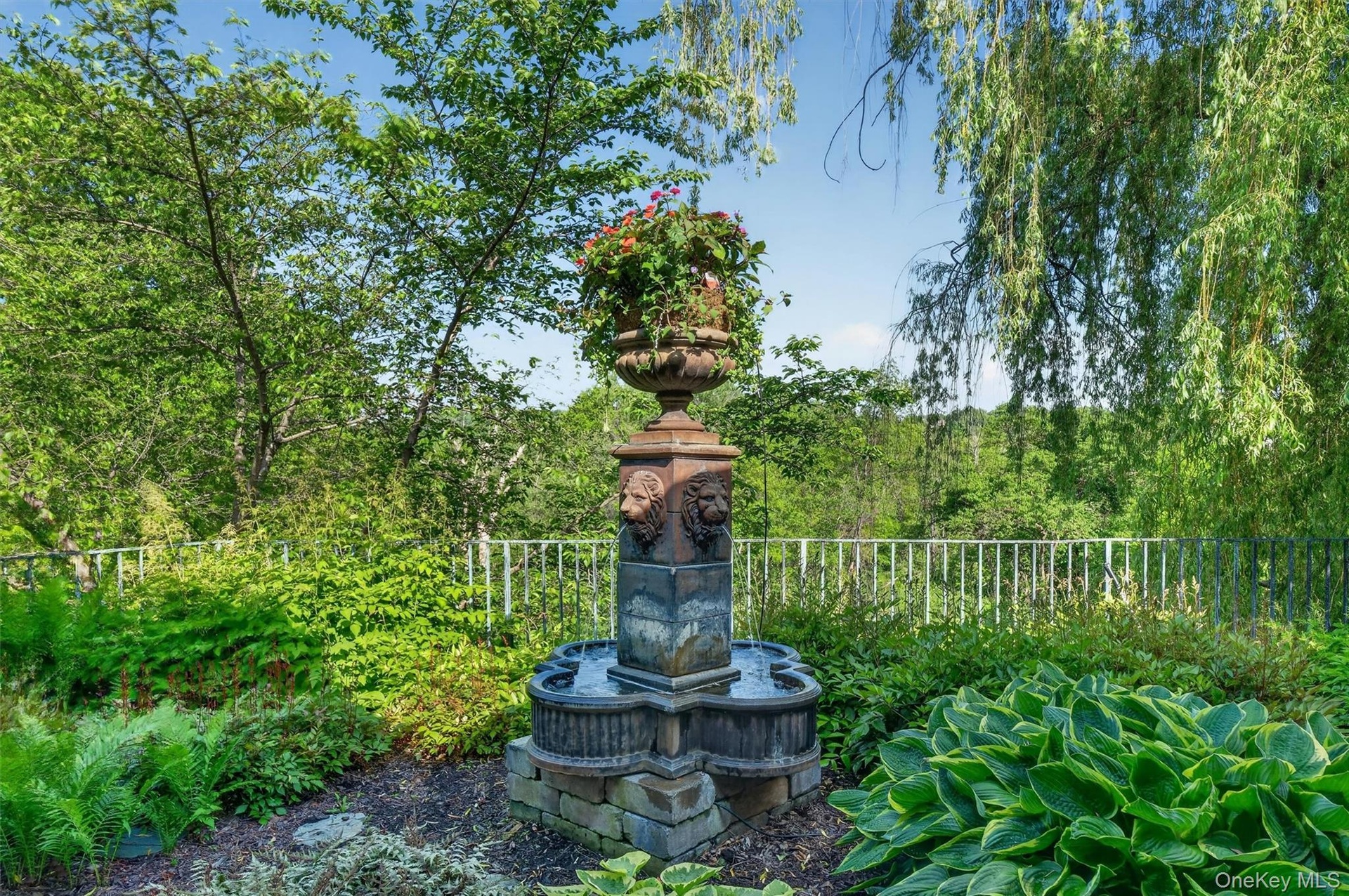 Mature gardens graced with statues, urns and water features are displayed throughout the property.  All urns and planters have automatic drip watering