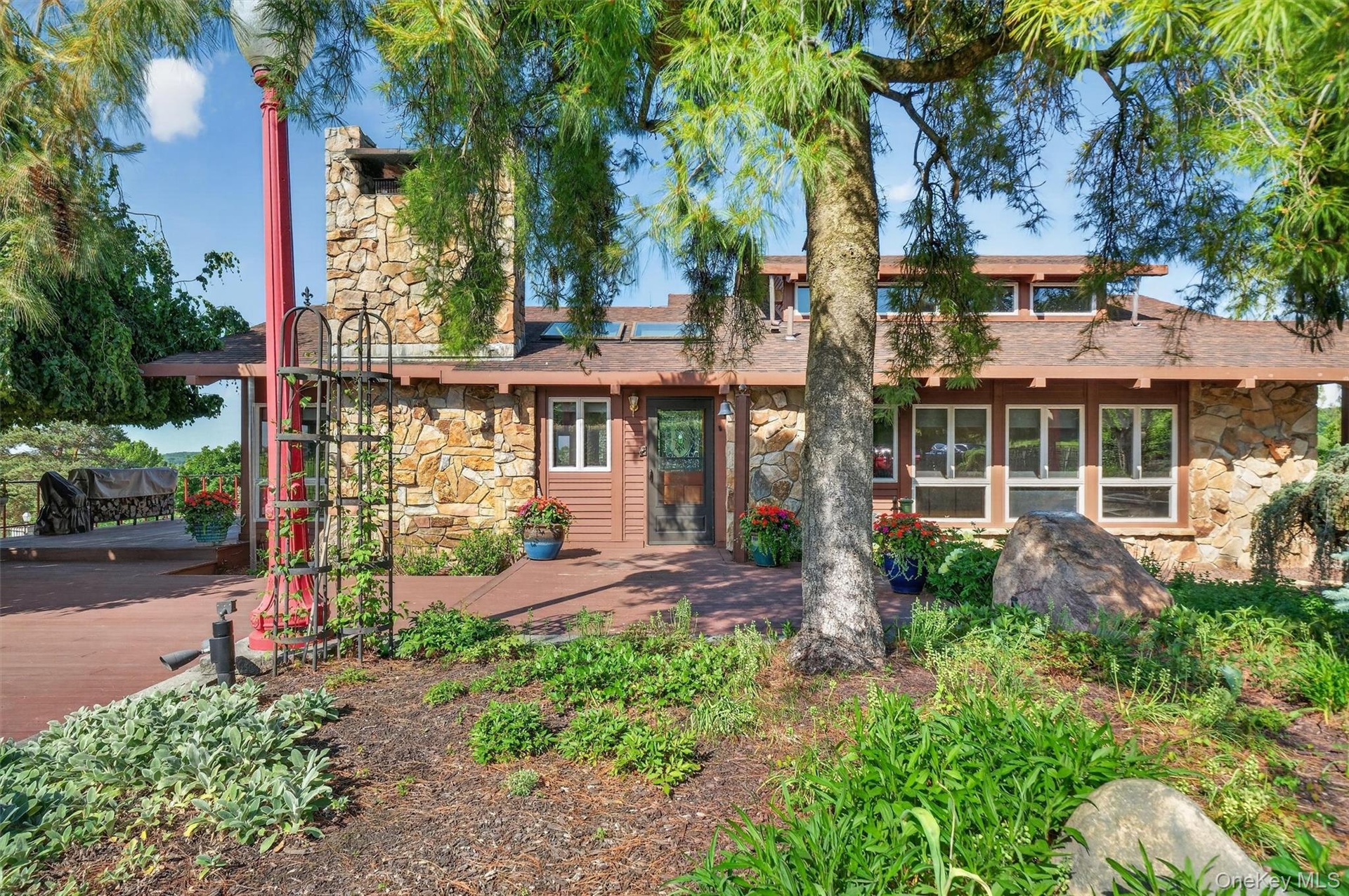Tucked away behind extensive gardens, the wood and stone home blends seamlessly with the property