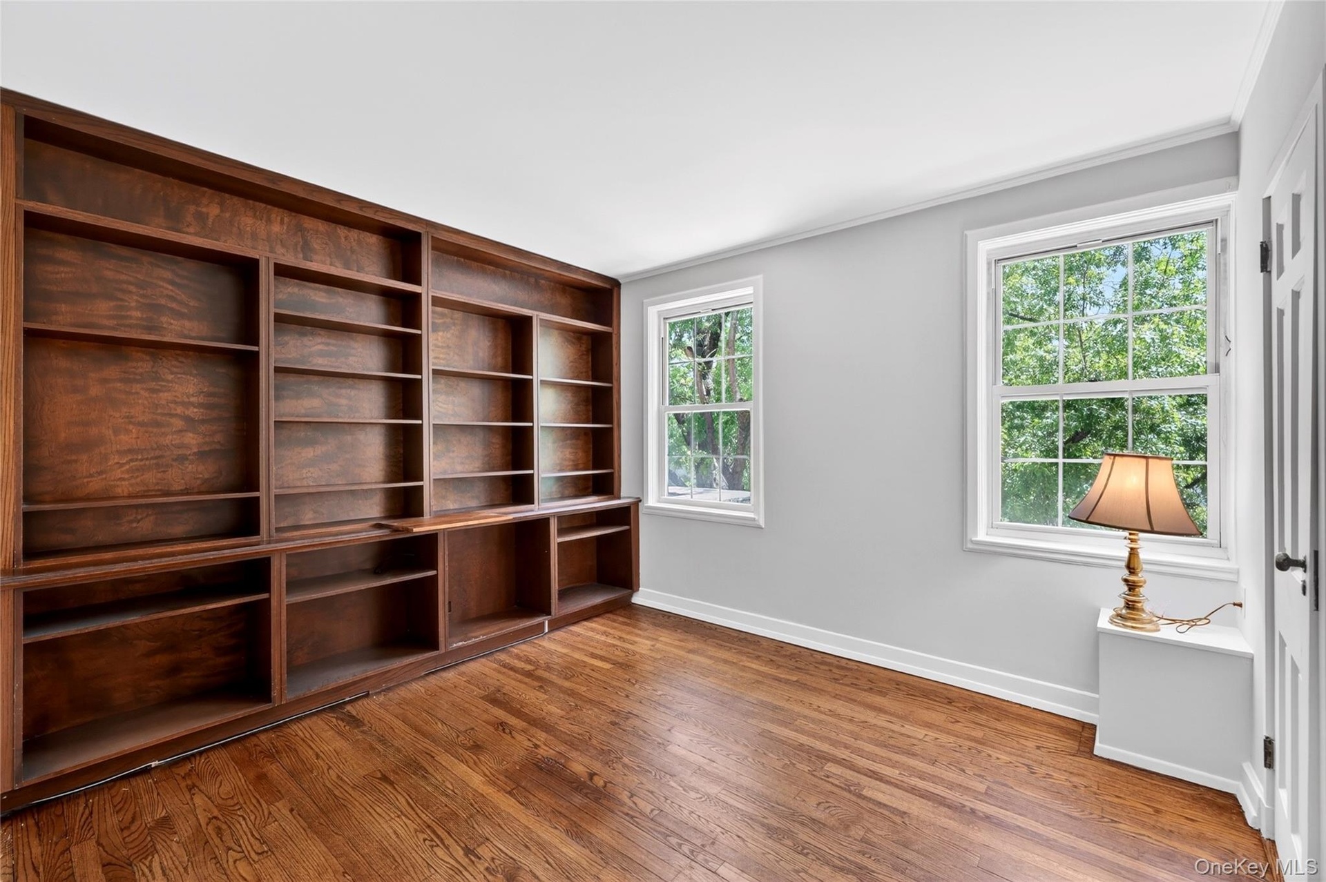 Bedroom #1 with an ensuite powder room and Built-in bookshelves. Perfect for Overnight Guests or as a Den.