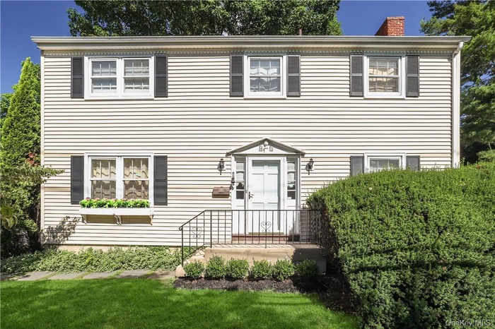 Colonial inspired home with a front lawn