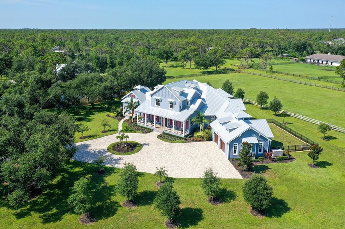 Experience unparalleled luxury and cutting-edge technology in this custom-built smart home at 6910 211th St E, Bradenton, FL 34211, designed with prem