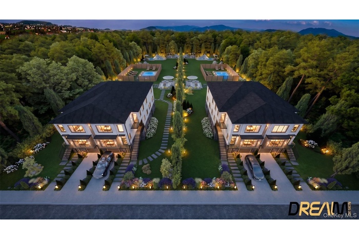 Modern twin residences featuring white exterior siding, dark roofs, and multiple windows