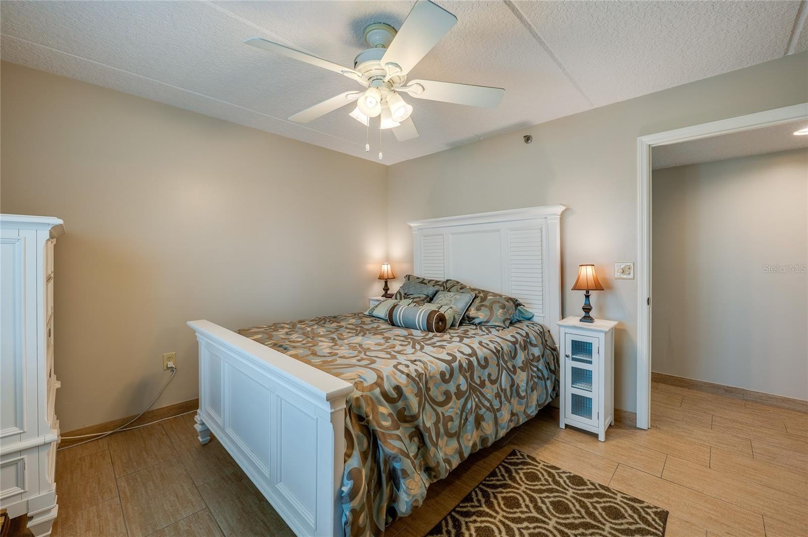 A second angle highlights the room's spacious layout, neutral palette, and direct access to the hallway for added convenience.