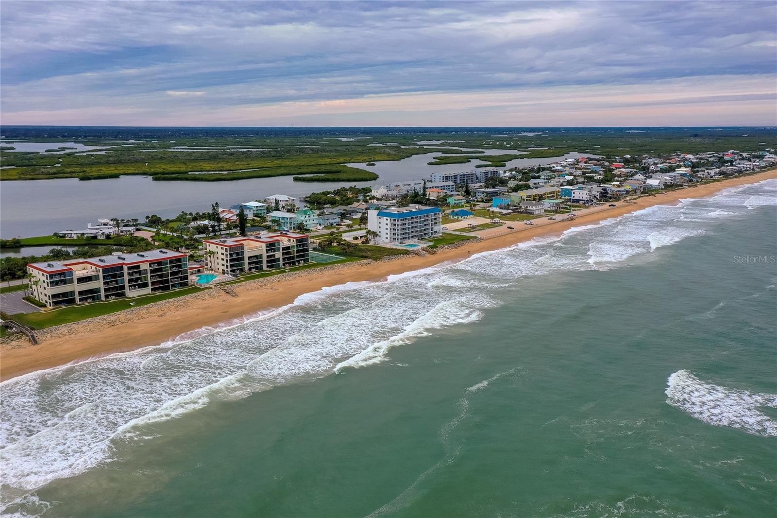 This expansive coastal view looks north along the beach, showcasing the quiet, residential stretch of New Smyrna’s no-drive zone.