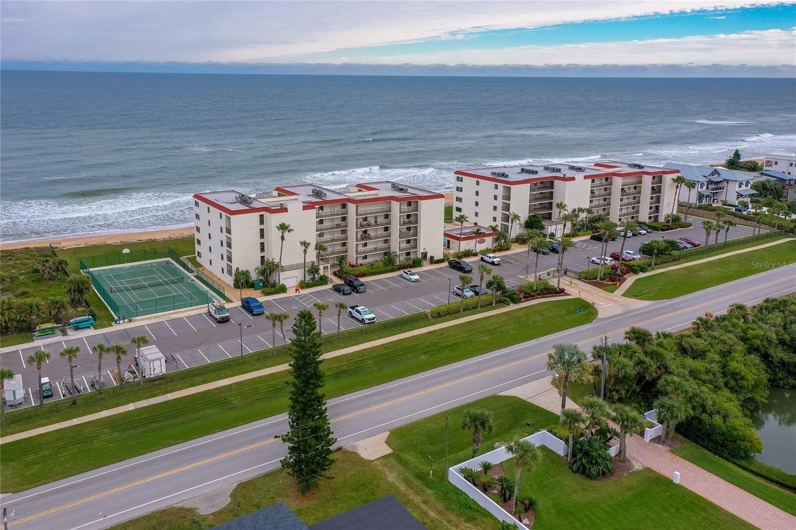 The amenities include a tennis court, ample guest and resident parking, and easy access to the main road—all within a secure and well-kept environment