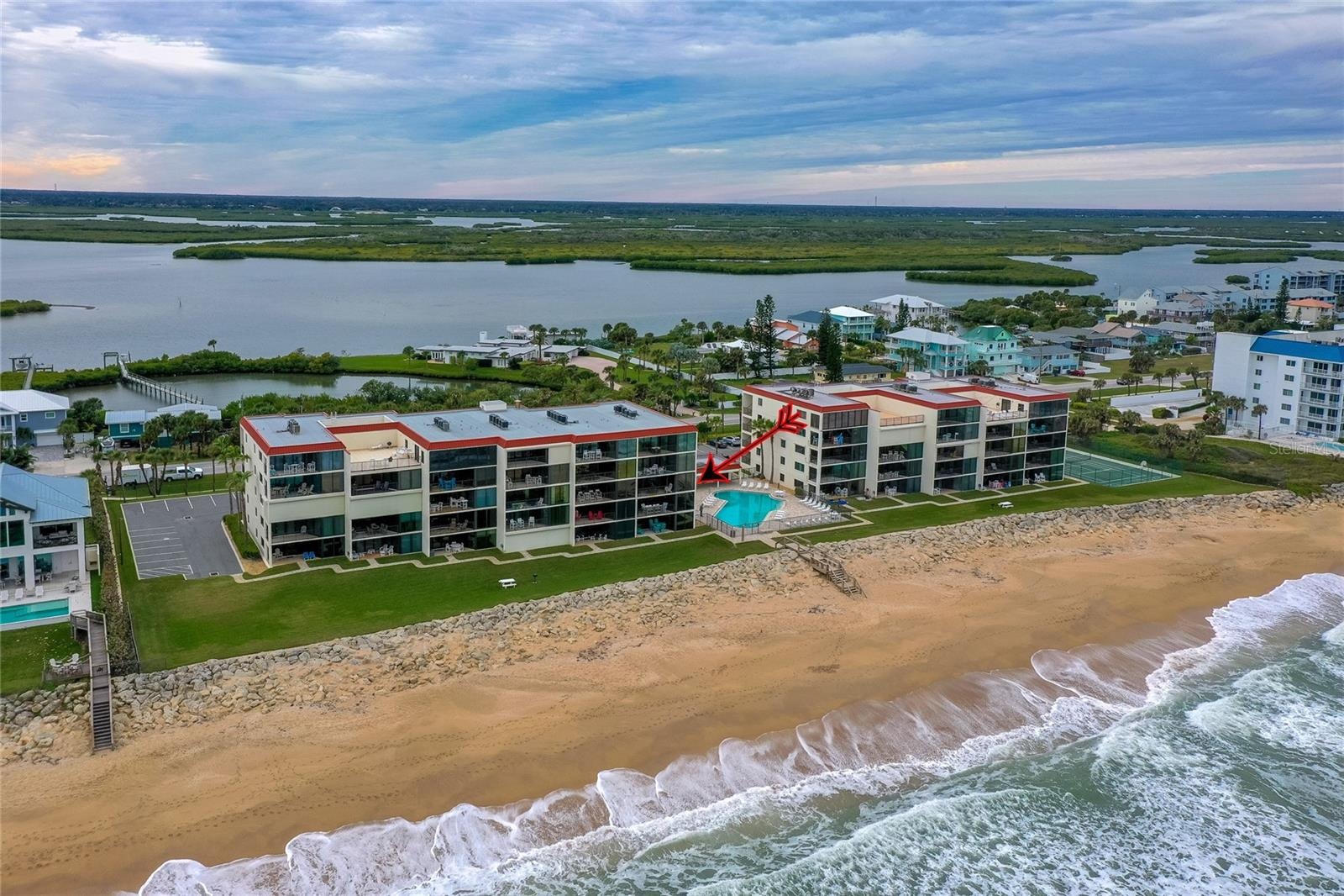 Positioned right on the sand, the oceanfront pool and beach access point are front and center, offering resort-style living with unparalleled coastal 