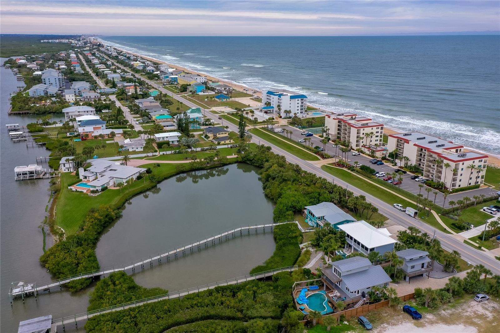 This rare barrier island location offers the best of both worlds: direct oceanfront living on one side and serene riverfront beauty on the other, all 