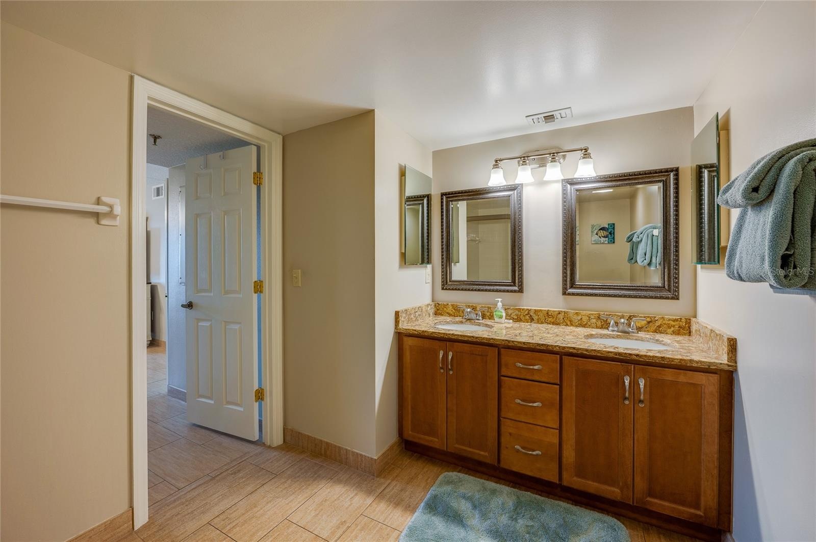 A wider view of the ensuite shows the thoughtful layout and bright lighting, ideal for daily routines.