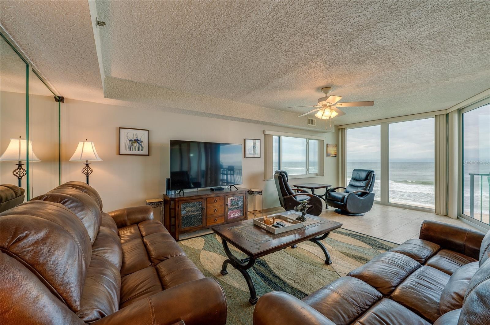 The living area features full-length windows with unobstructed ocean views and access to the balcony an ideal setting for relaxing or hosting guests.