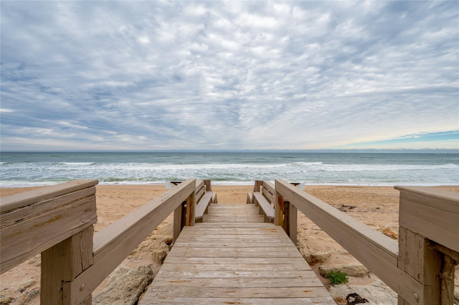 A private boardwalk leads directly from the community to the sandy shoreline, offering effortless access to the beach just steps from your door.