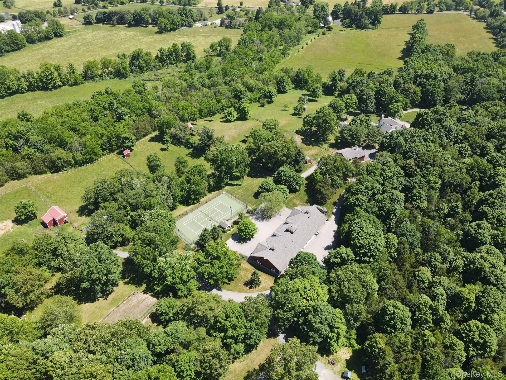 Property aerial showing residence and outbuildings