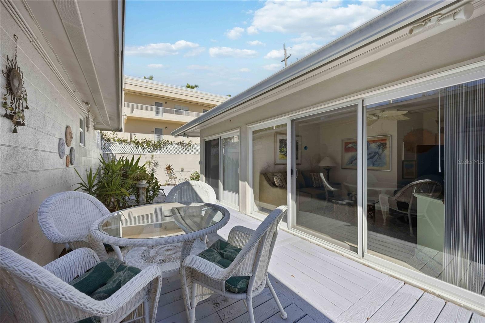 Wall of sliding glass doors to your private courtyard