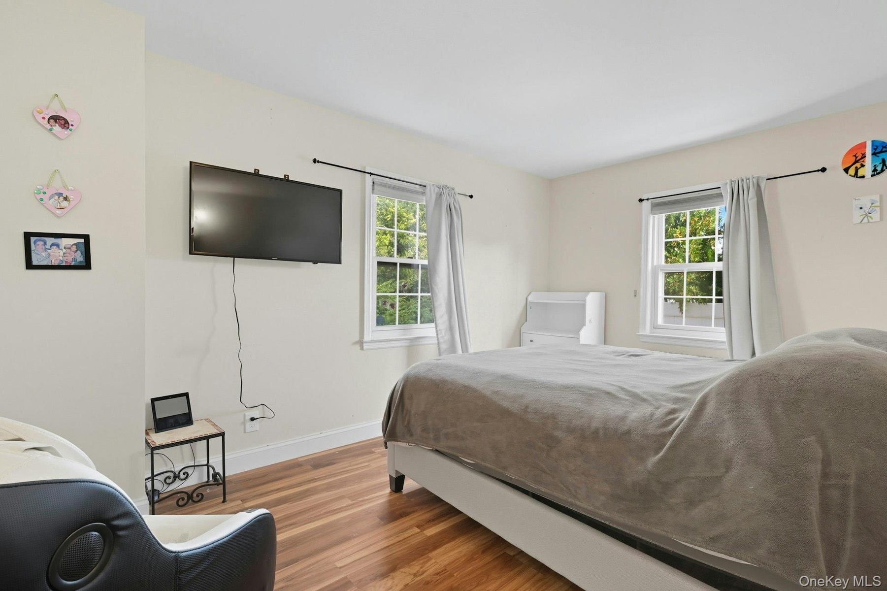 Bedroom with wood finished floors and baseboards
