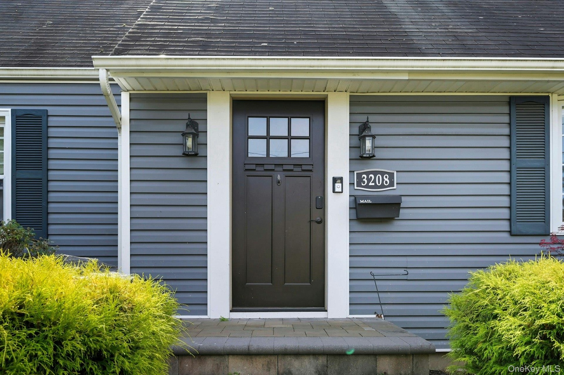 Property entrance featuring roof with shingles