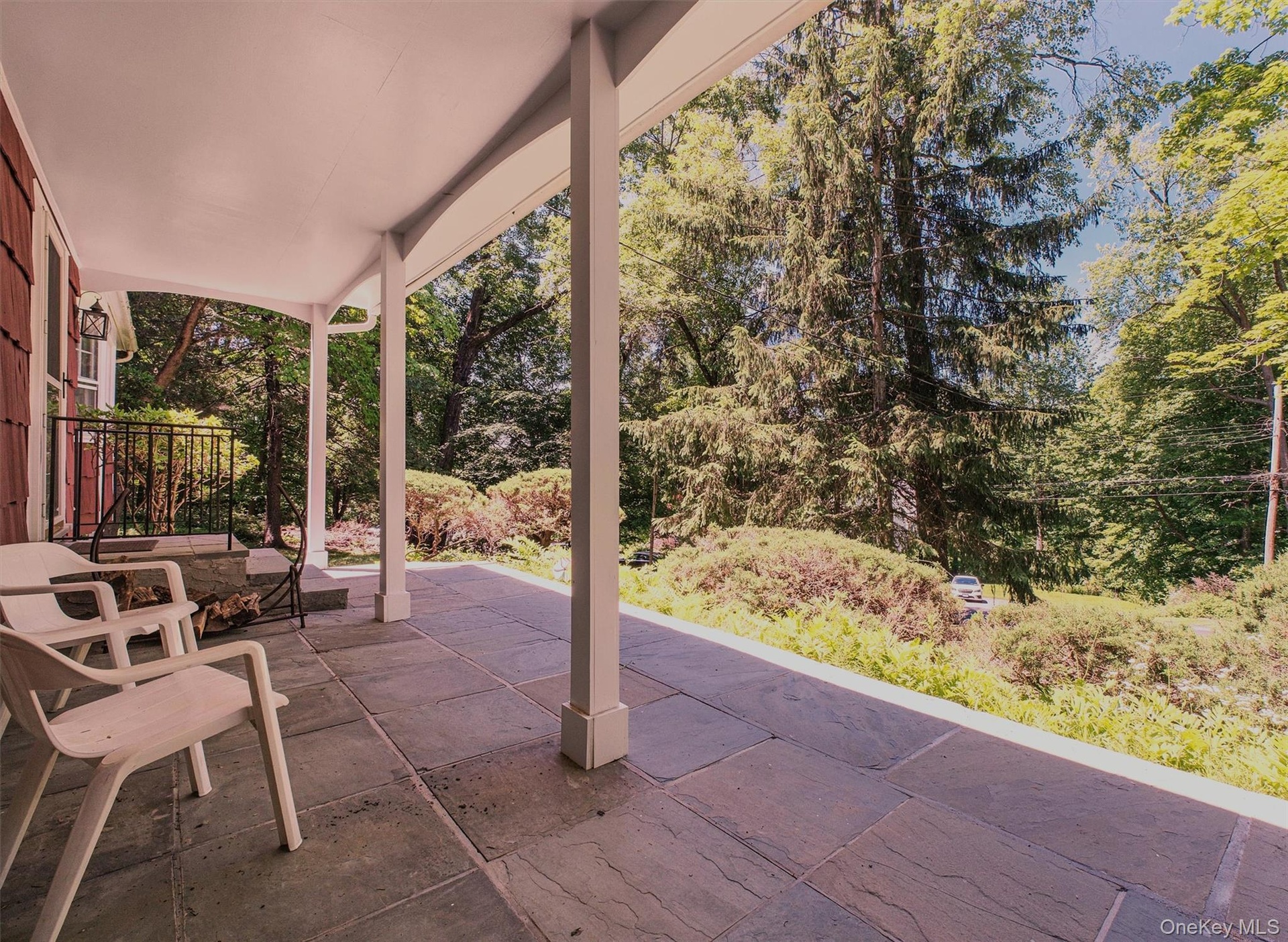Covered front porch featuring large format stone tile flooring