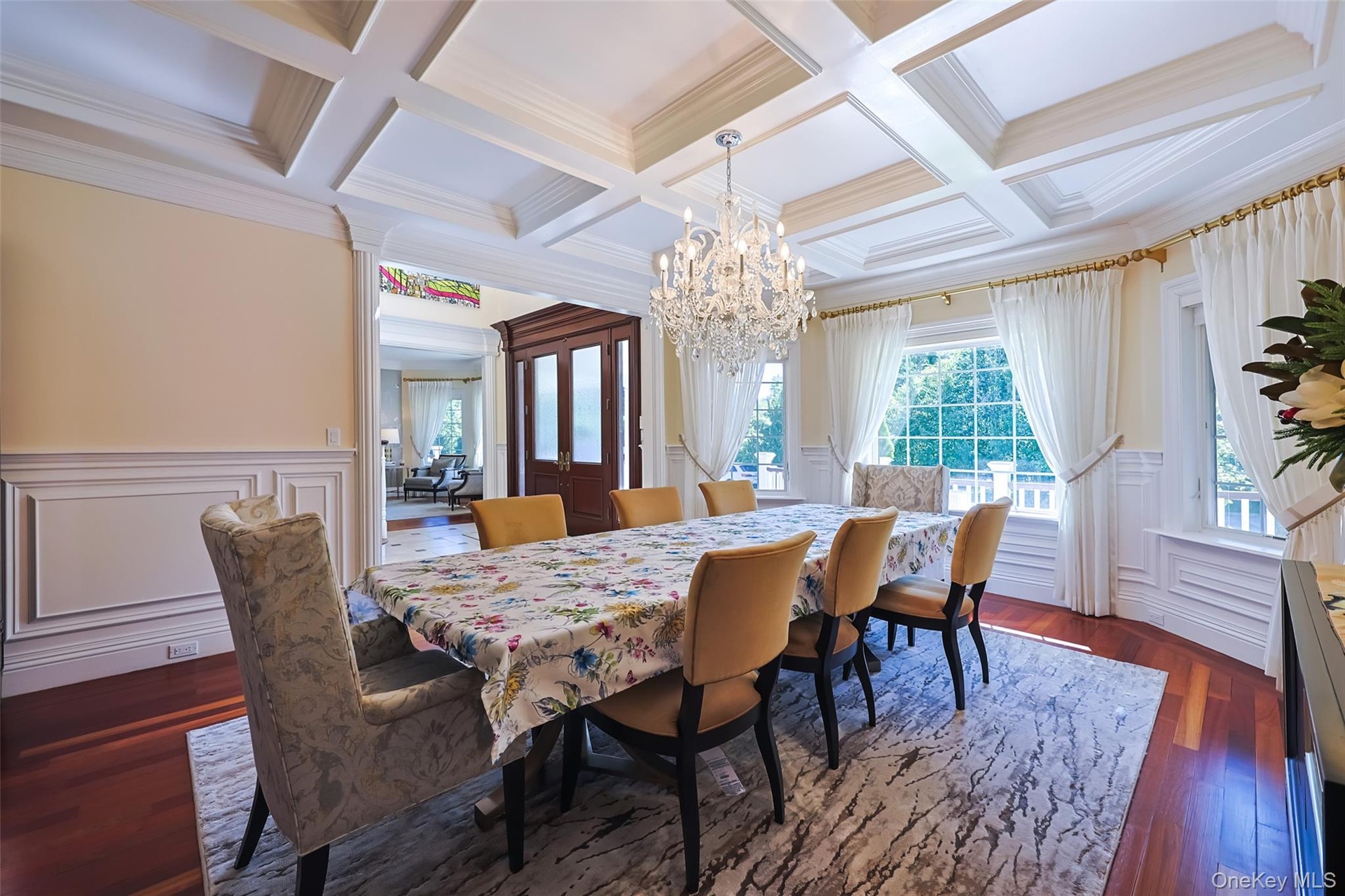 Coffered ceiling featuring a crystal chandelier