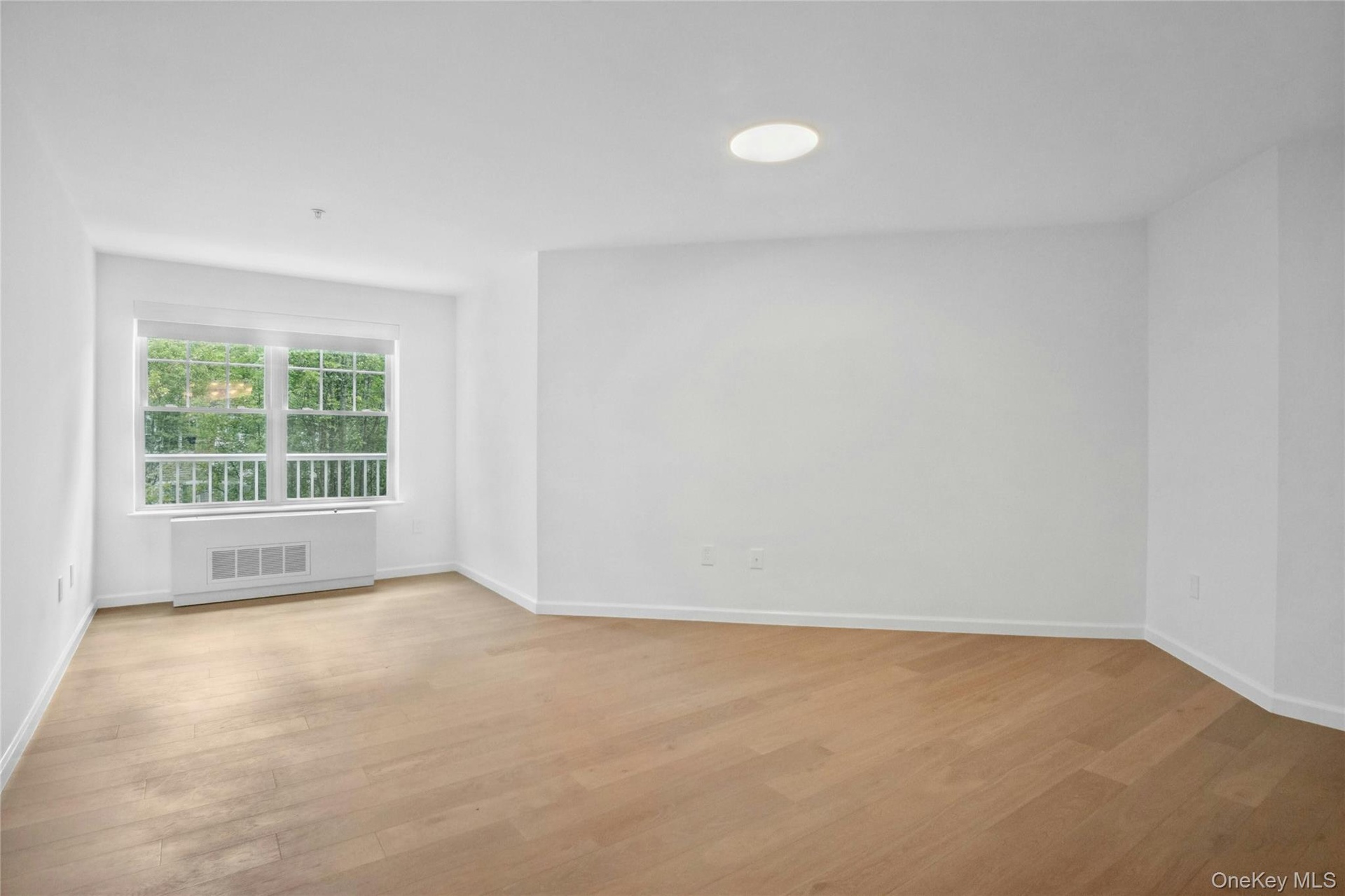 King sized primary bedroom with updated lighting and cozy windowed reading nook with remote controlled motorized shades