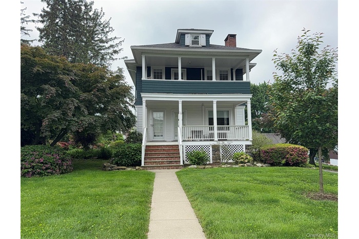 American foursquare style home with covered front porch