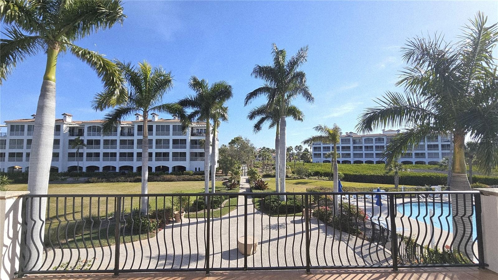 View of large heated pool + spa